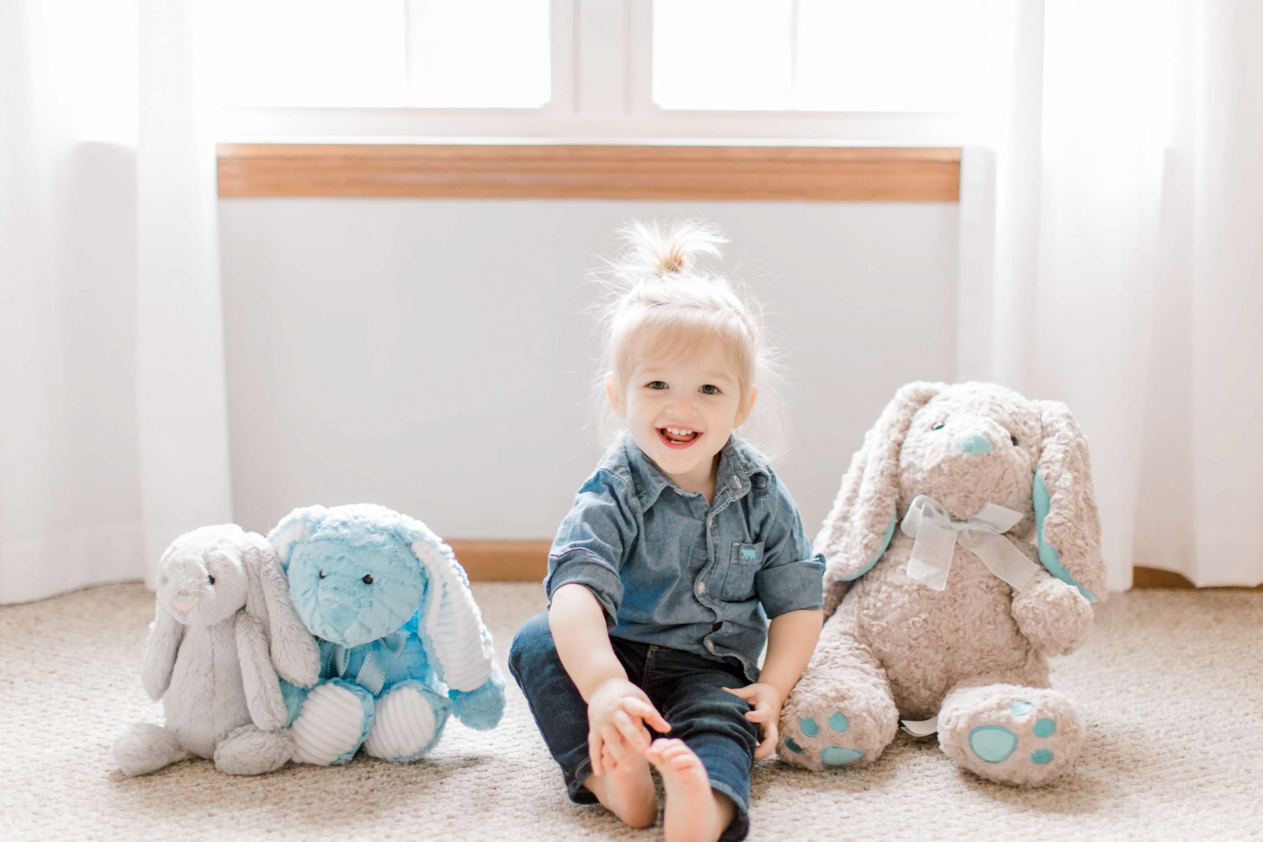 toddler boy with stuffed Easter bunnies