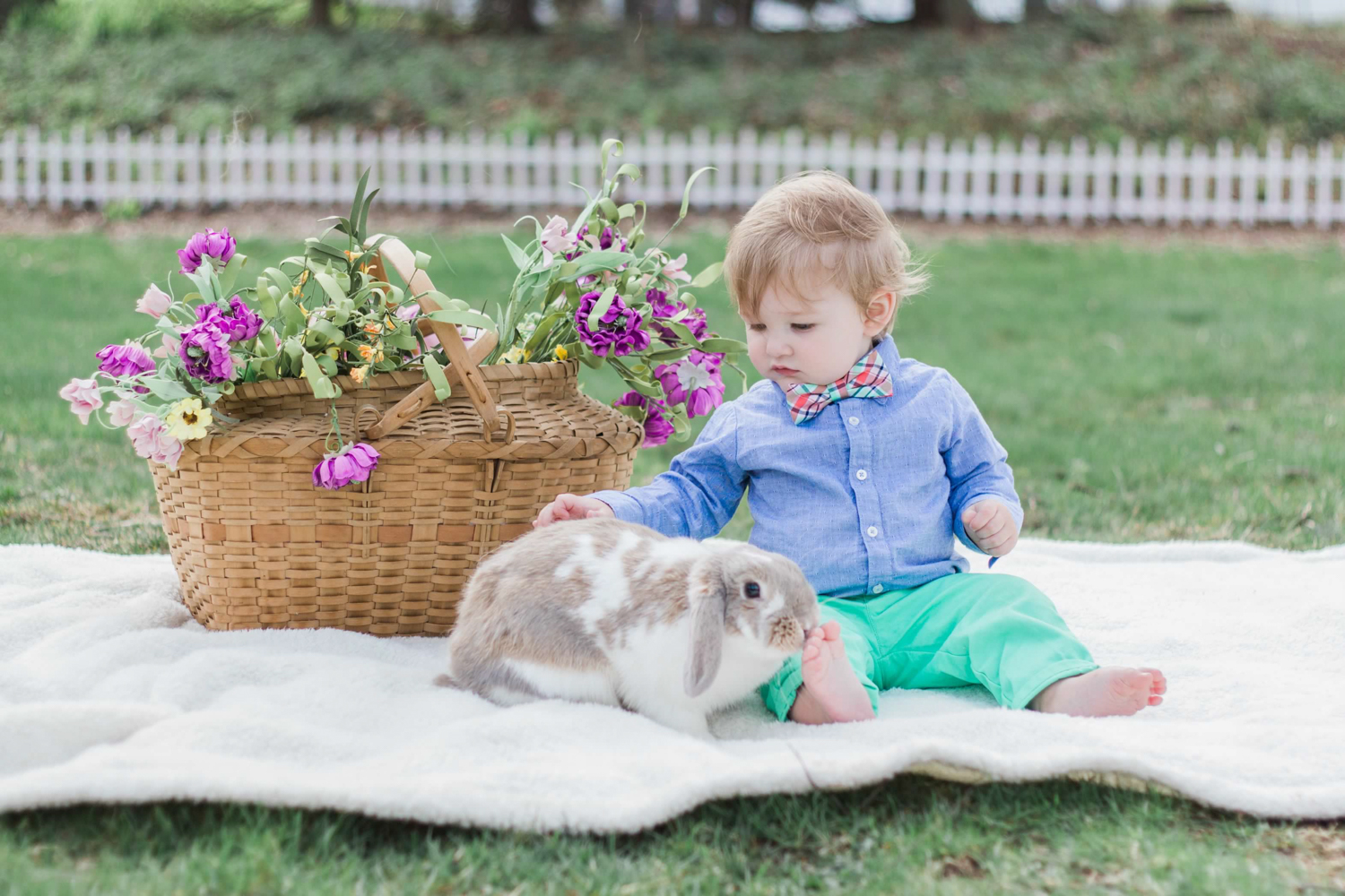 baby with bunny on blanket outside on easter