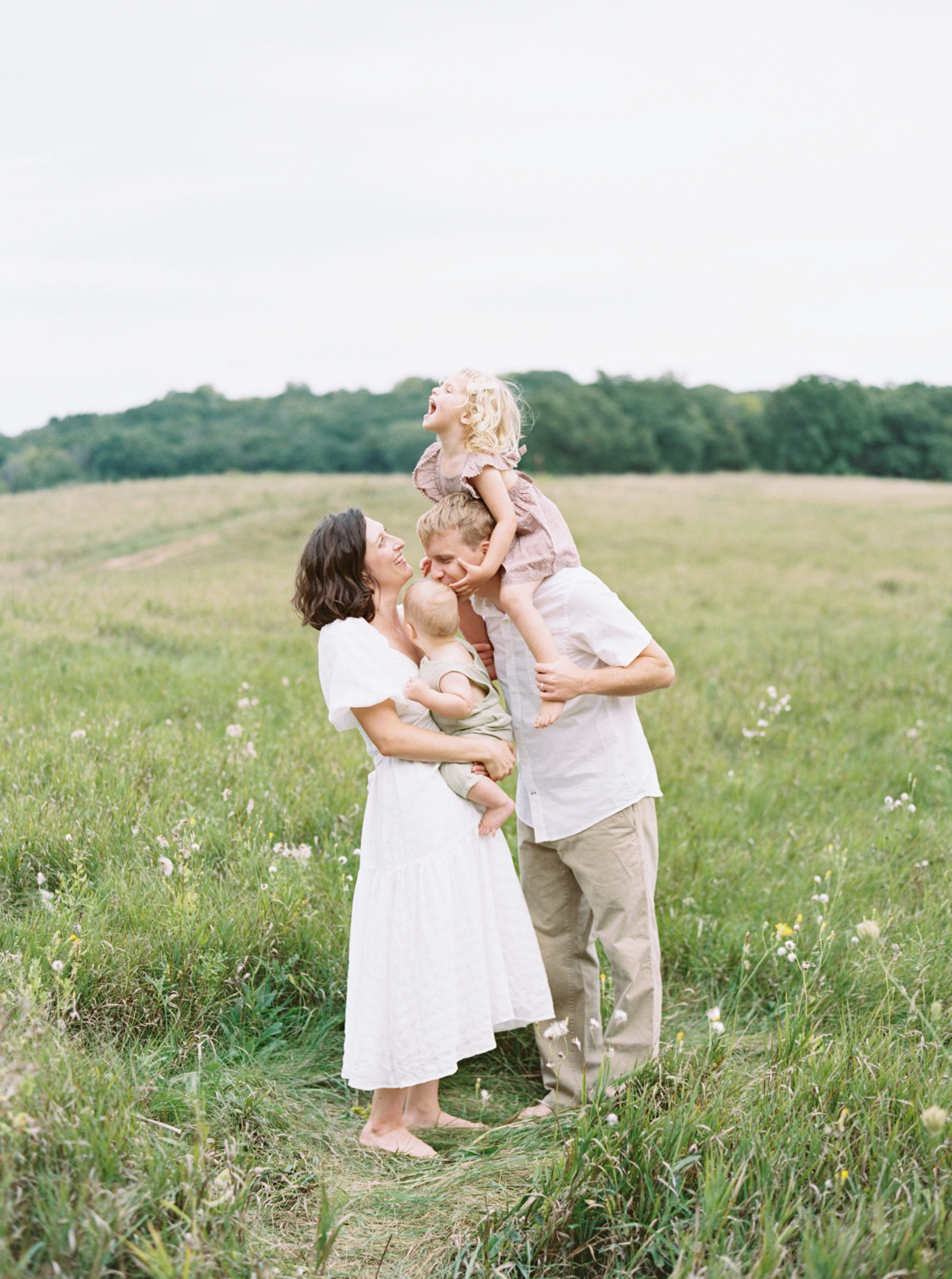 family portrait in a grassy green field setting in Milwaukee in the summer