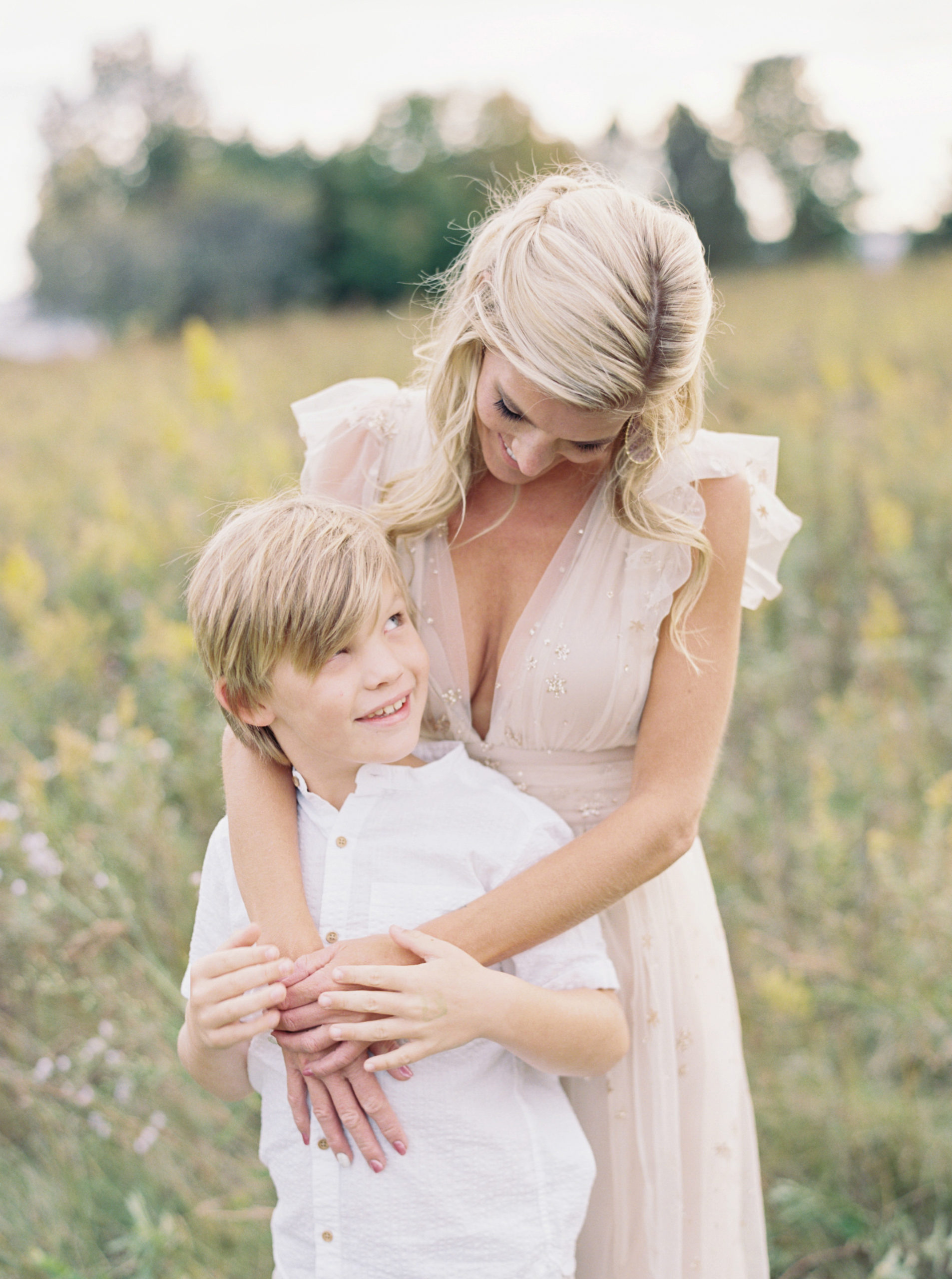 Mother and Son cuddle in beautiful middleton grassy field