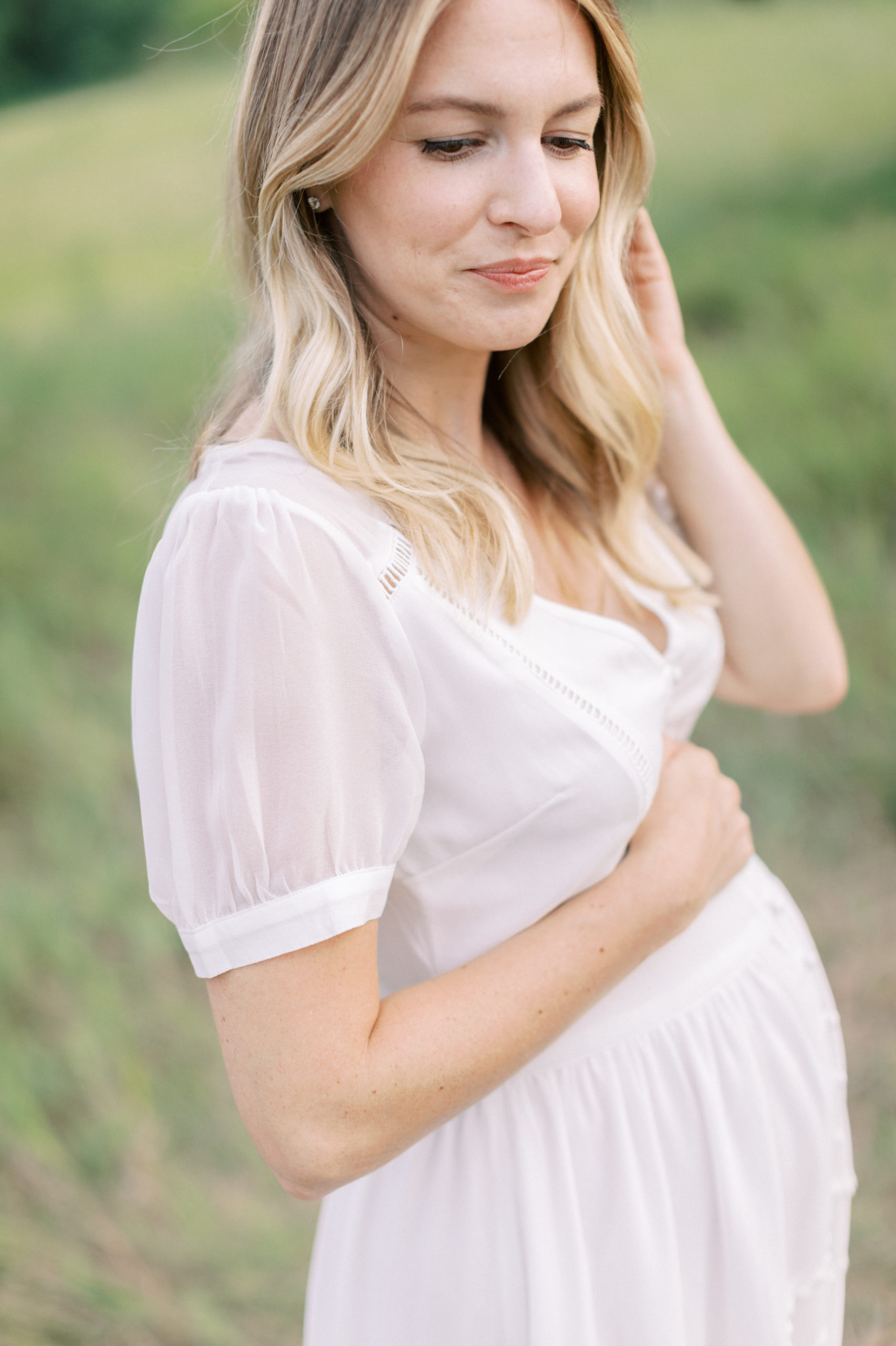 beautiful blonde pregnant mom in a white dress for maternity photos