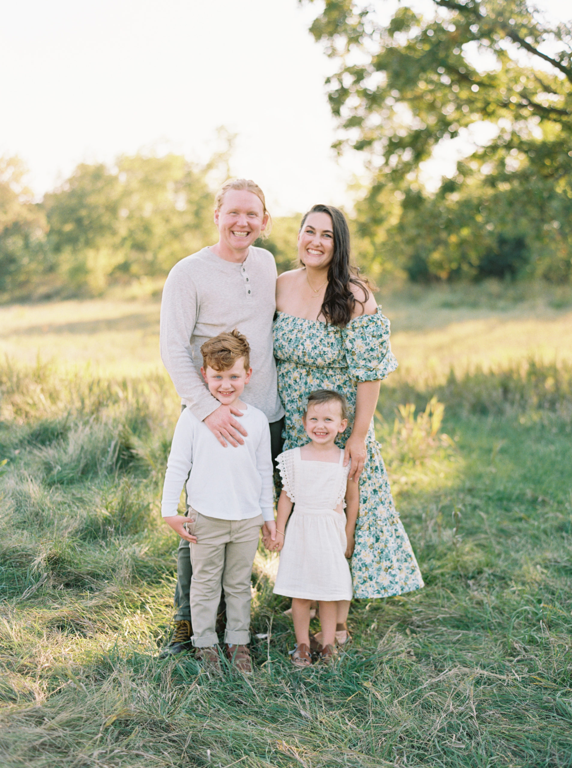 family portrait in a grassy green field setting in Shorewood in the summer