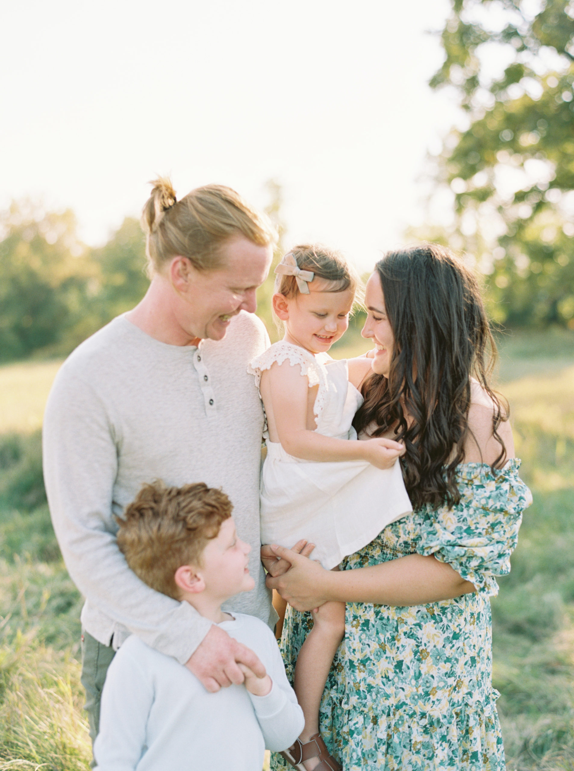 family portrait in a grassy green field setting in Shorewood in the summer