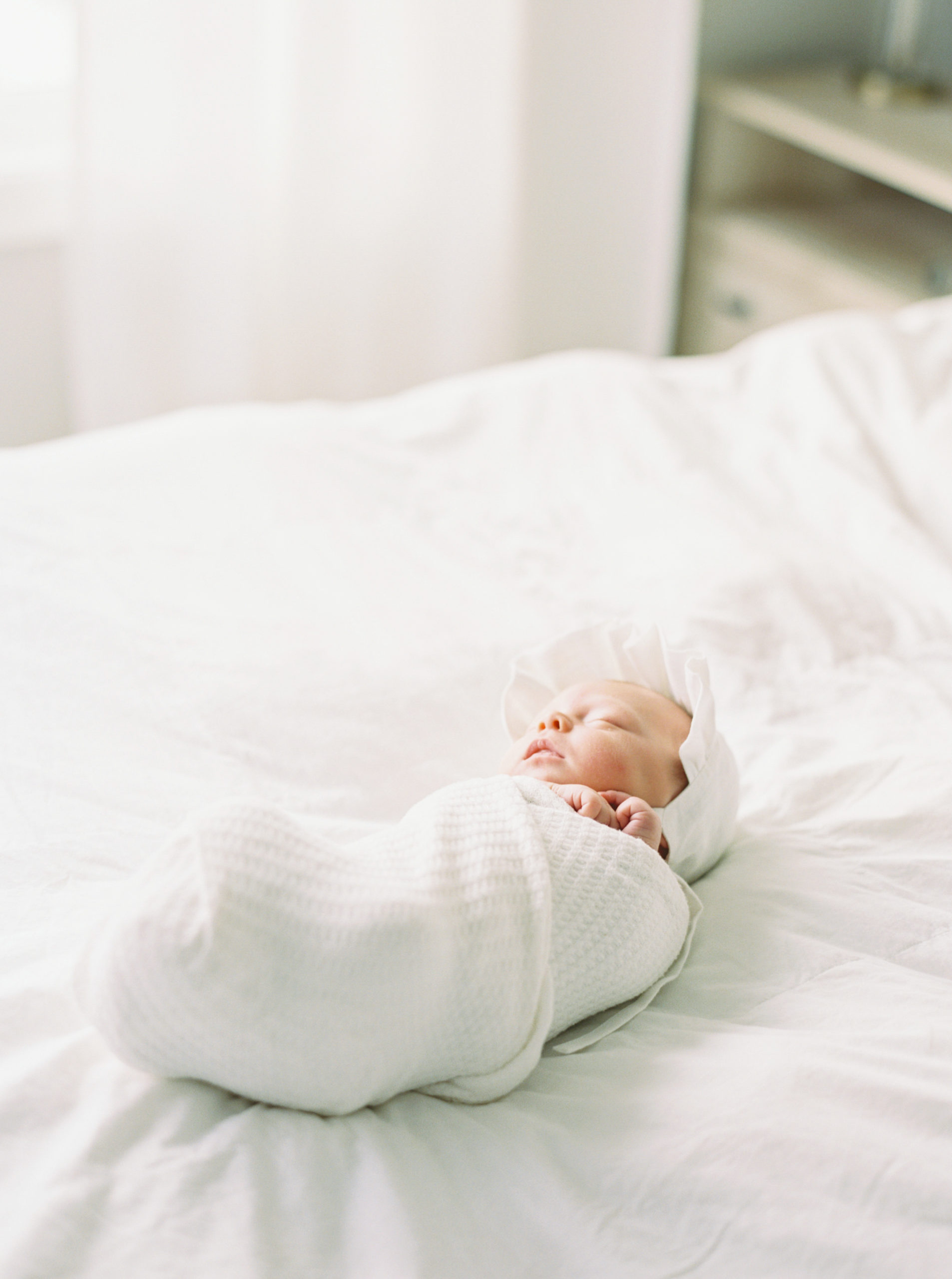 sleeping newborn in white bright bedroom taken by photographer in milwaukee Talia laird photography