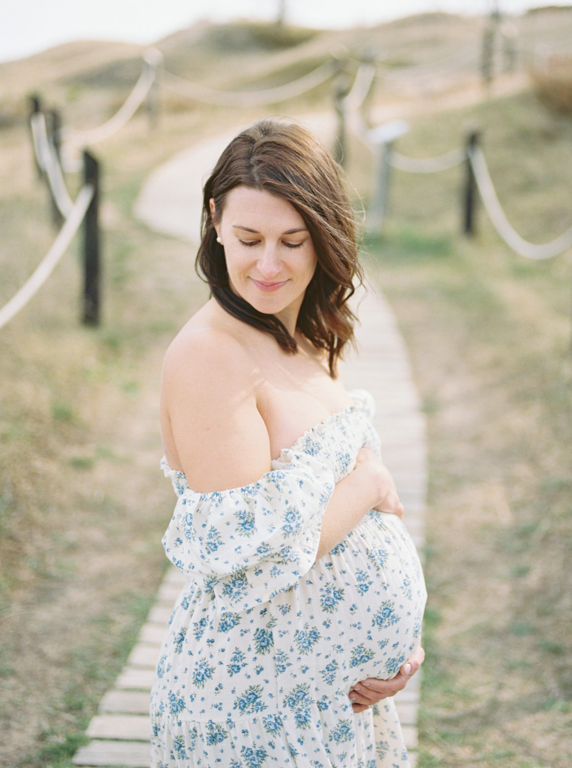 photo of pregnant mother in floral dress taken by milwaukee maternity photographer Talia Laird Photography