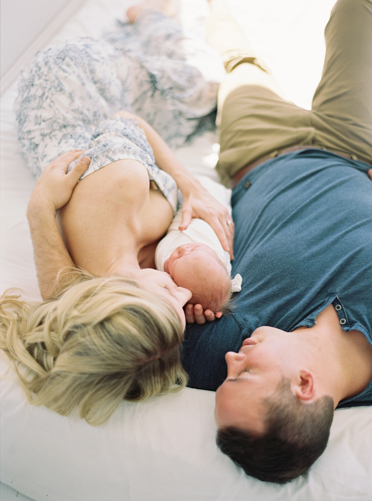 beautiful couple holding newborn baby taken by milwaukee photographers Talia Laird Photography