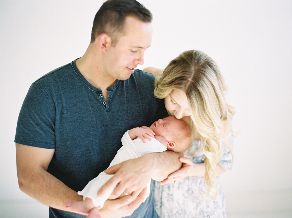 couple holding new baby boy taken by Milwaukee Photographers Talia Laird Photography