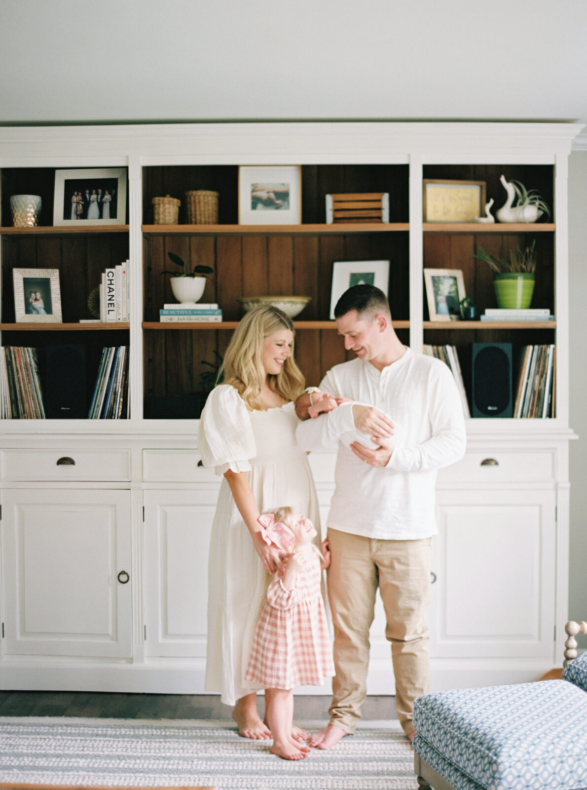 family of four snuggled together during in home newborn session in milwaukee, wi photographed by Talia Laird Photography