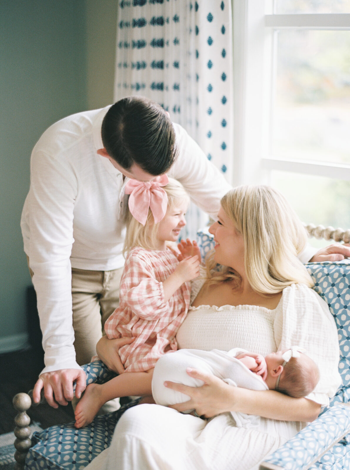 family of four snuggled together during in home newborn session in milwaukee, wi photographed by Talia Laird Photography