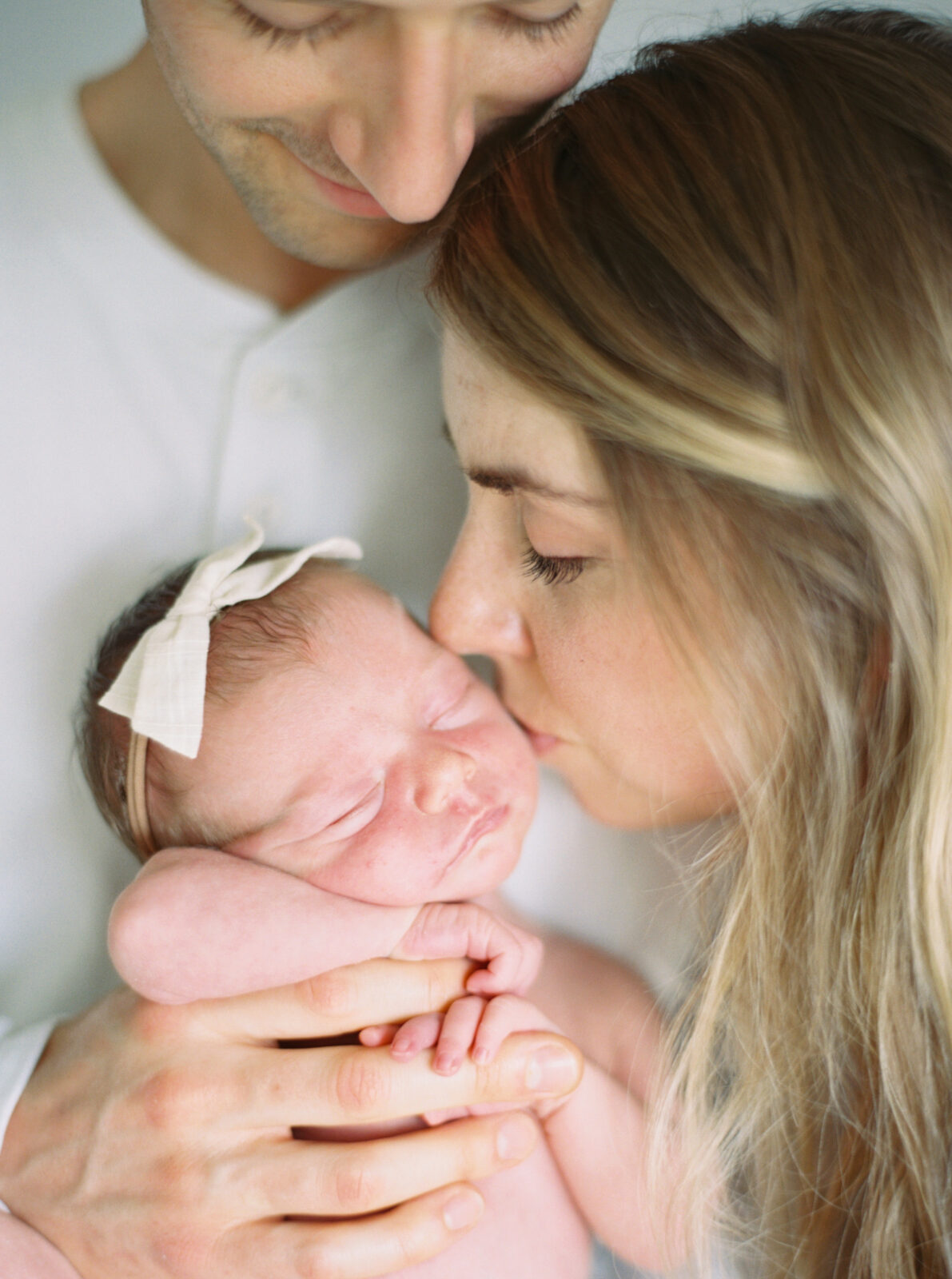 close up of mom kissing baby in milwaukee studio newborn session with Talia Laird Photography