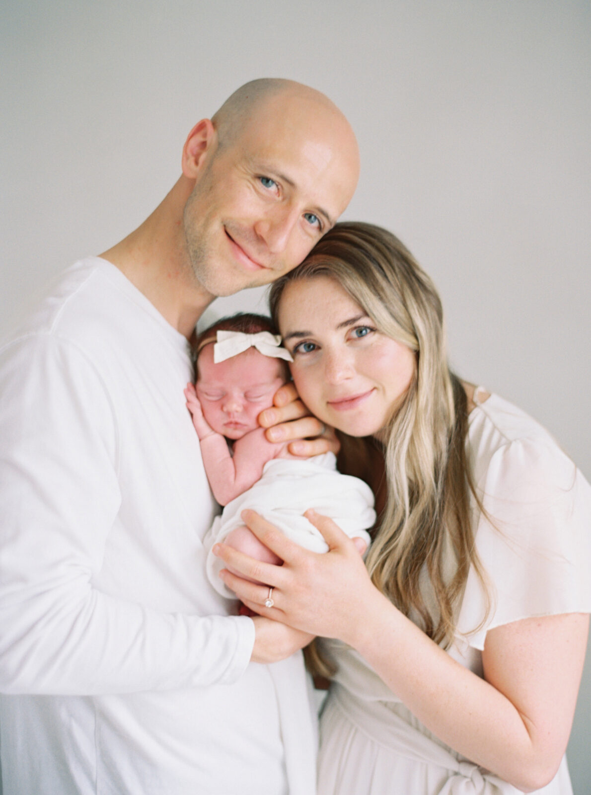 parents holding brand newborn baby in milwaukee studio newborn session with Talia Laird Photography
